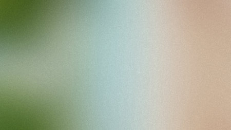 A blurred gradient transitions from green to blue and beige with a subtle grain texture.の写真素材