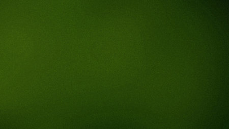 A deep forest green textured background with a subtle grain and a dark vignette effect.の写真素材