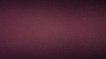 A deep burgundy gradient background with a fine grain texture and subtle diffused light.の写真素材