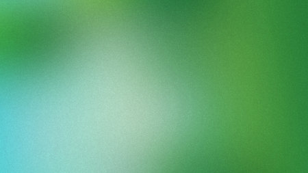 A soft gradient background with a subtle grain effect transitioning from light blue to green.の写真素材