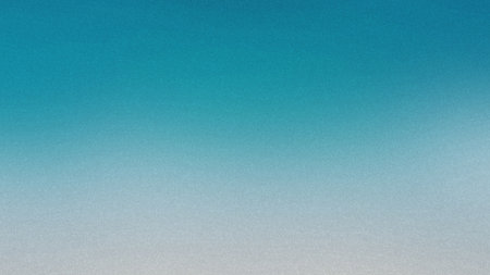 A smooth gradient transitions from light blue to white with a fine grain texture. Clear details a...の写真素材