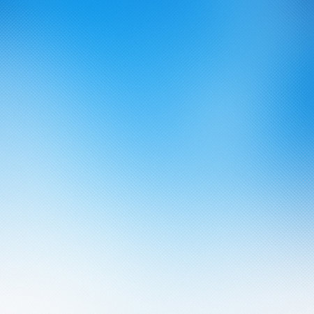 Bright blue sky gradient with a subtle textured overlay and a soft transition to white at the...の写真素材