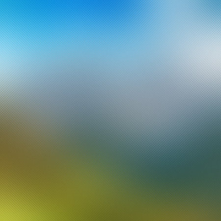 A textured gradient blending a blue sky at the top with a green field at the bottom.の写真素材