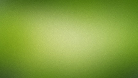 A soft yellowish green gradient background with a subtle fine grain texture and diffused light.の写真素材