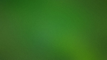 A vibrant green gradient with a speckled texture creates a lively and natural background.の写真素材