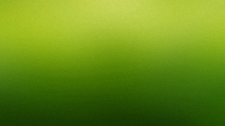 A vibrant green gradient background with a speckled texture, transitioning from light to dark green.の写真素材