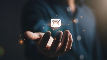 Hand holding a glowing digital icon of an envelope with sparkling lights around it. Clear details...の写真素材