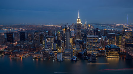 New york city skyline illuminated at twilight reflecting beautifully on the tranquil river