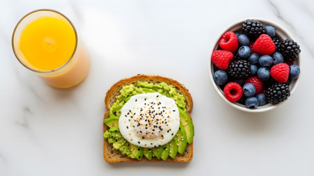A delicious and healthy breakfast spread with avocado toast, berries, and fresh orange juiceの写真素材