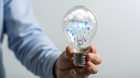 Binary showing person holding lightbulb with cloud and binary code inside against a light...の写真素材