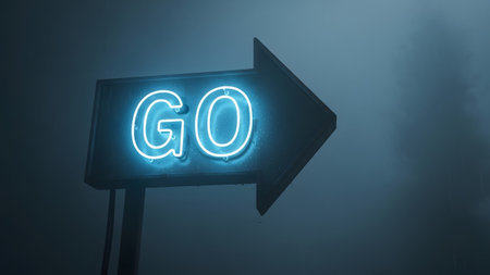 Illuminated showing blue neon arrow sign with the word go illuminated in a dark, misty...