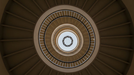 A spiral concrete staircase viewed from below with a camera aperture symbol at the...の写真素材