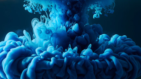 showing abstract blue ink cloud swirling in dark water creating organic shapes and...