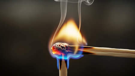 showing burning wooden match igniting another match with bright orange flame and white...