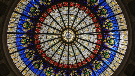 Radiating showing colorful circular stained glass dome ceiling with radiating geometric patterns...