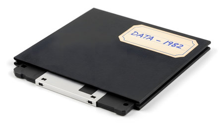 With showing black floppy disk case labeled data 1982 with silver metal insert. resolution...