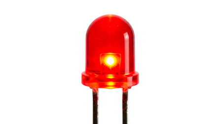 Stock showing close up of a single red light emitting diode led with metal leads on white...