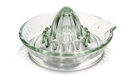 Juicer showing clear glass citrus juicer with ribbed reamer and pouring spout on white...