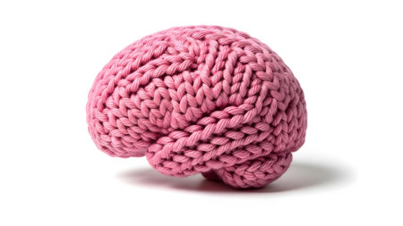 Intricate showing knitted pink brain sculpture with intricate stitch detail on a clean white...