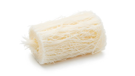 showing rectangular block of dry white vermicelli noodles isolated on white background....