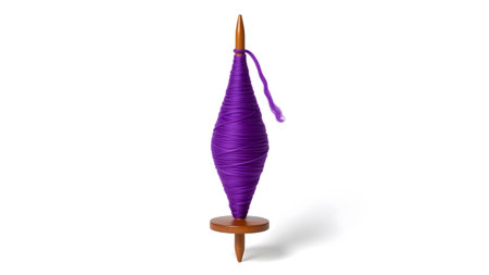 showing purple yarn wound on a wooden spinning spindle with white background.