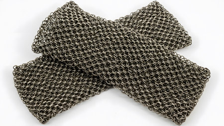 Wristbands showing two metal chainmail wristbands crossed on white background. resolution...