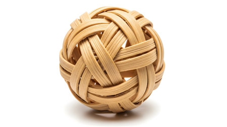 a round, woven rattan ball, a traditional used in the sport of Sepak Takraw, isolated on white.