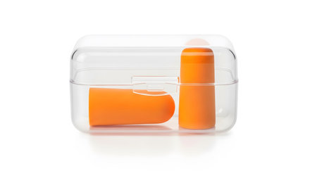 Stock showing two orange earplugs standing upright inside a clear protective case on white...