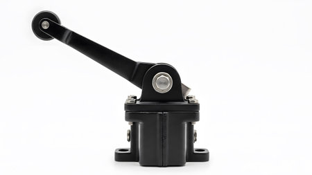 Roller showing black industrial limit switch with a roller lever arm and mounting base on white...