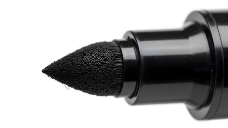 Black showing black marker pen tip with porous foamy nib and textured surface on white...の写真素材