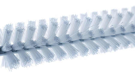 Handle showing close up macro shot of a clean white bristled brush with a metallic handle on a...