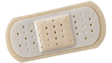 Square showing close up of a beige fabric bandage with a white perforated adhesive pad and a...