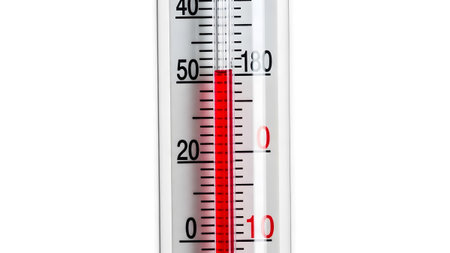 Close showing close up of a laboratory thermometer showing a red liquid column indicating a...