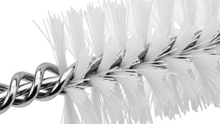 A detailed macro shot of a white bristled cleaning brush with a twisted metal wire handle...