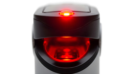 Close-up of a device with a bright red illuminated indicator light and a visible internal red glow.