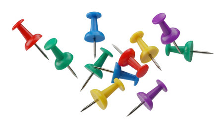 A collection of scattered colorful push pins with sharp metal points on a white background.