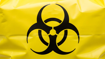 Detailed view of yellow biohazard waste bag texture with black symbol.