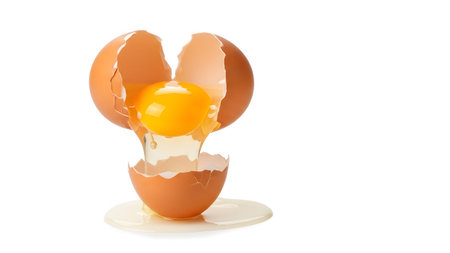 Background showing cracked brown egg revealing golden yolk dripping onto white surface with...