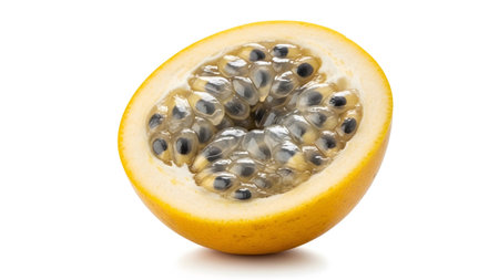 Passion showing half of a ripe yellow passion fruit showing translucent pulp and black seeds on...