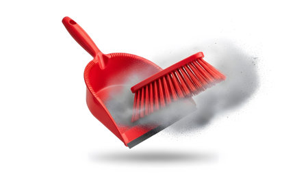 Particles showing red dustpan and brush with flying dust particles isolated on white.