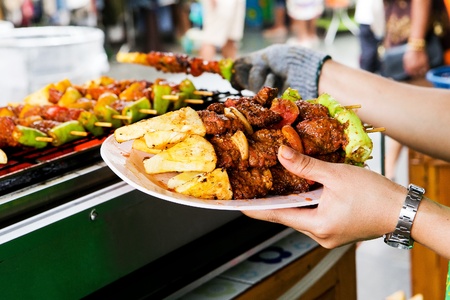 Barbecue grill, placed on a white plate in hand の写真素材