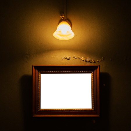 Vintage frame on concrete wall with lampの写真素材