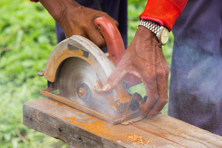 Detail of circular saw cutting piece of woodの写真素材
