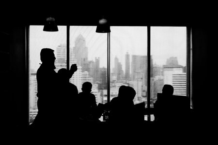 businessmen in a backlight on the tallest building in Bangkok.