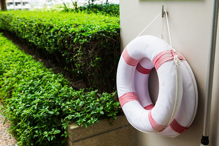 Life buoy attached to the concrete waterfront.の写真素材