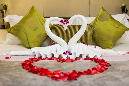 towel swans shaped on luxury bed,Honey moon bedの写真素材