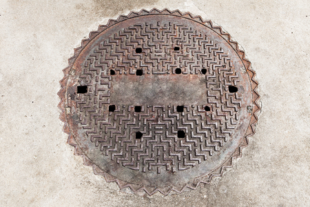 Manhole cover on the brick ground floorの写真素材