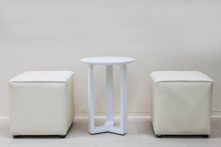 White table and white stools in white roomの写真素材