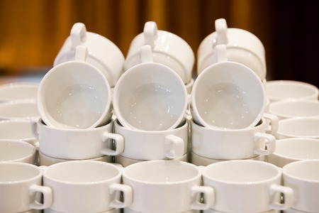 White cups for tea piled on table  for coffee-breakの写真素材