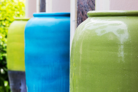 Colored of jars in the garden on groundの写真素材